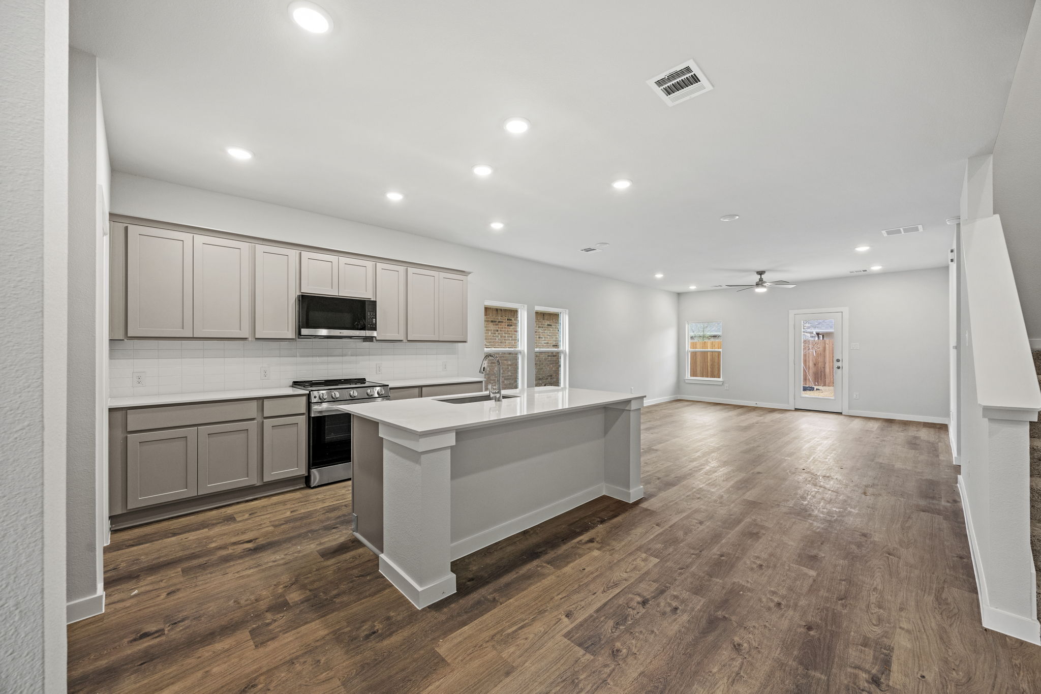 A kitchen with white cabinets.