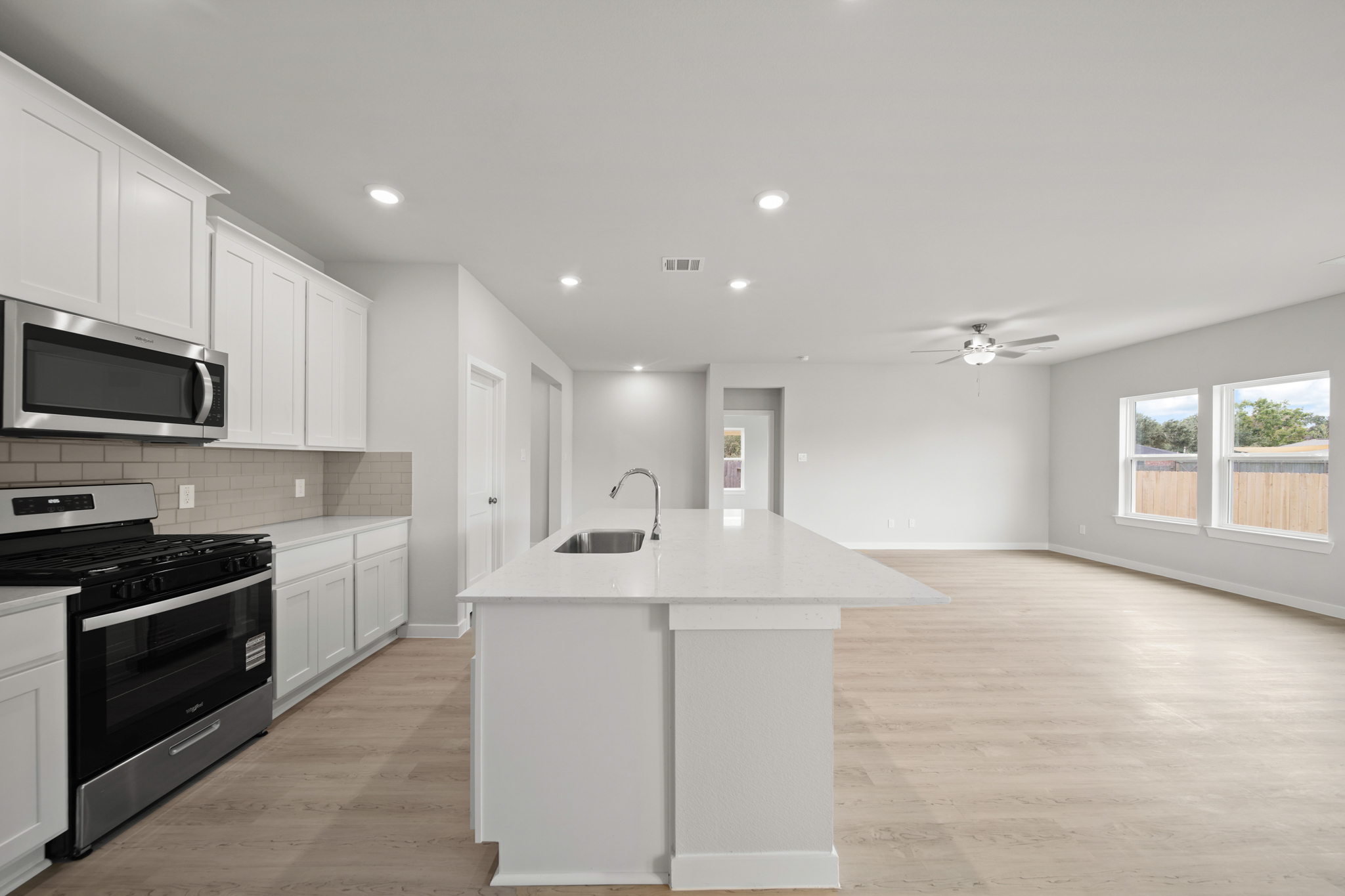 A kitchen with white cabinets.