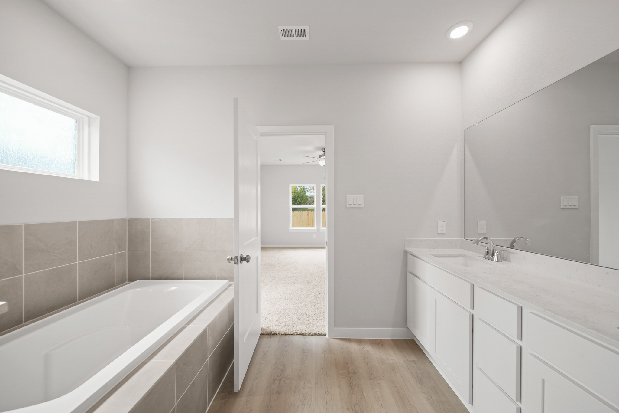 A bathroom with a tub and sink.