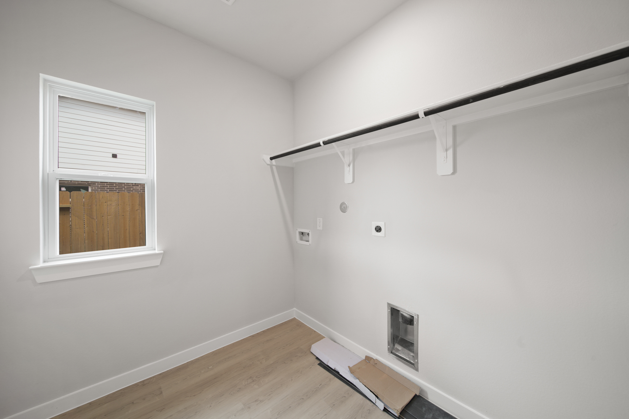 A room with a wood floor and a window.