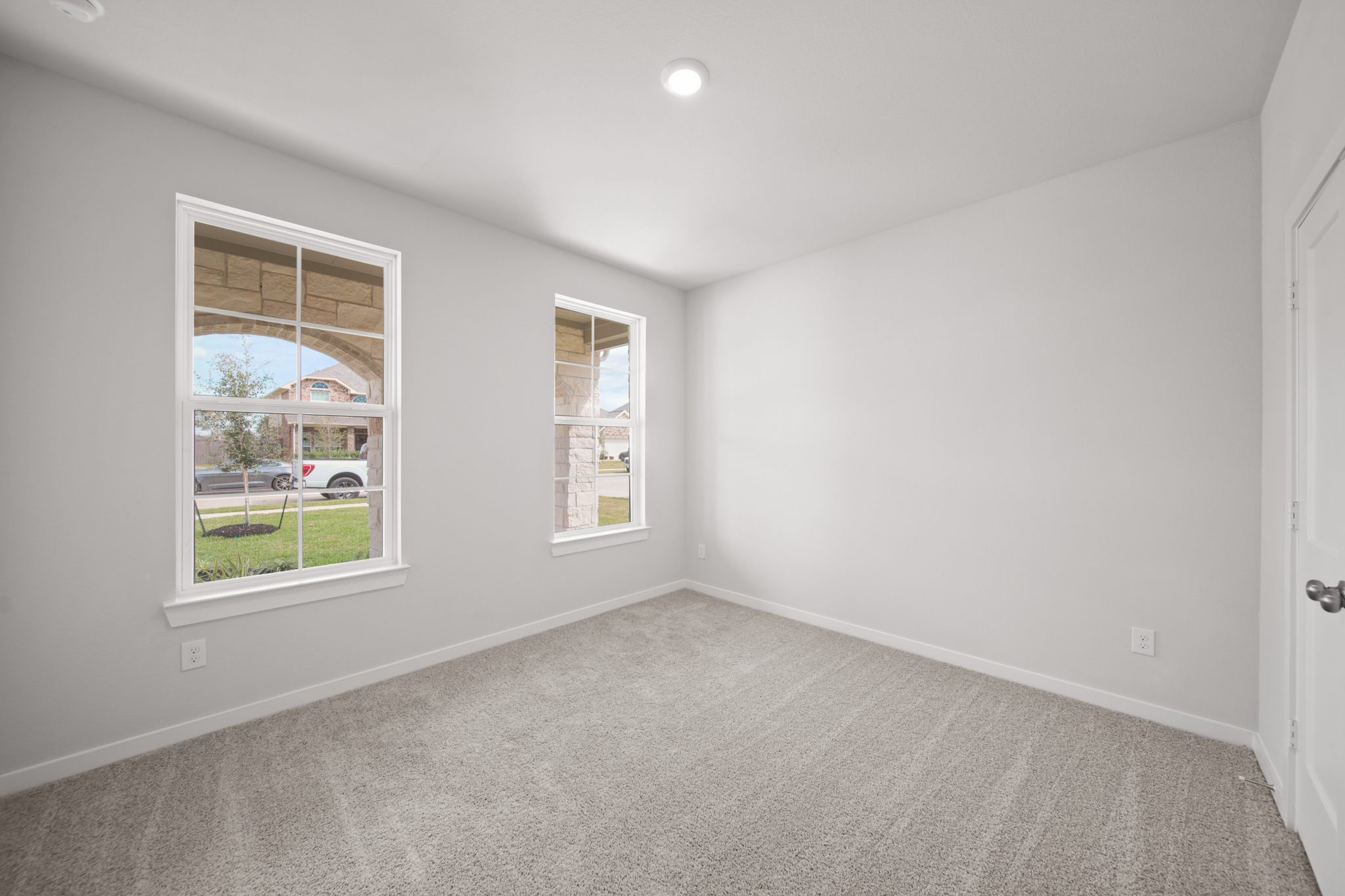 A room with a window and a door.