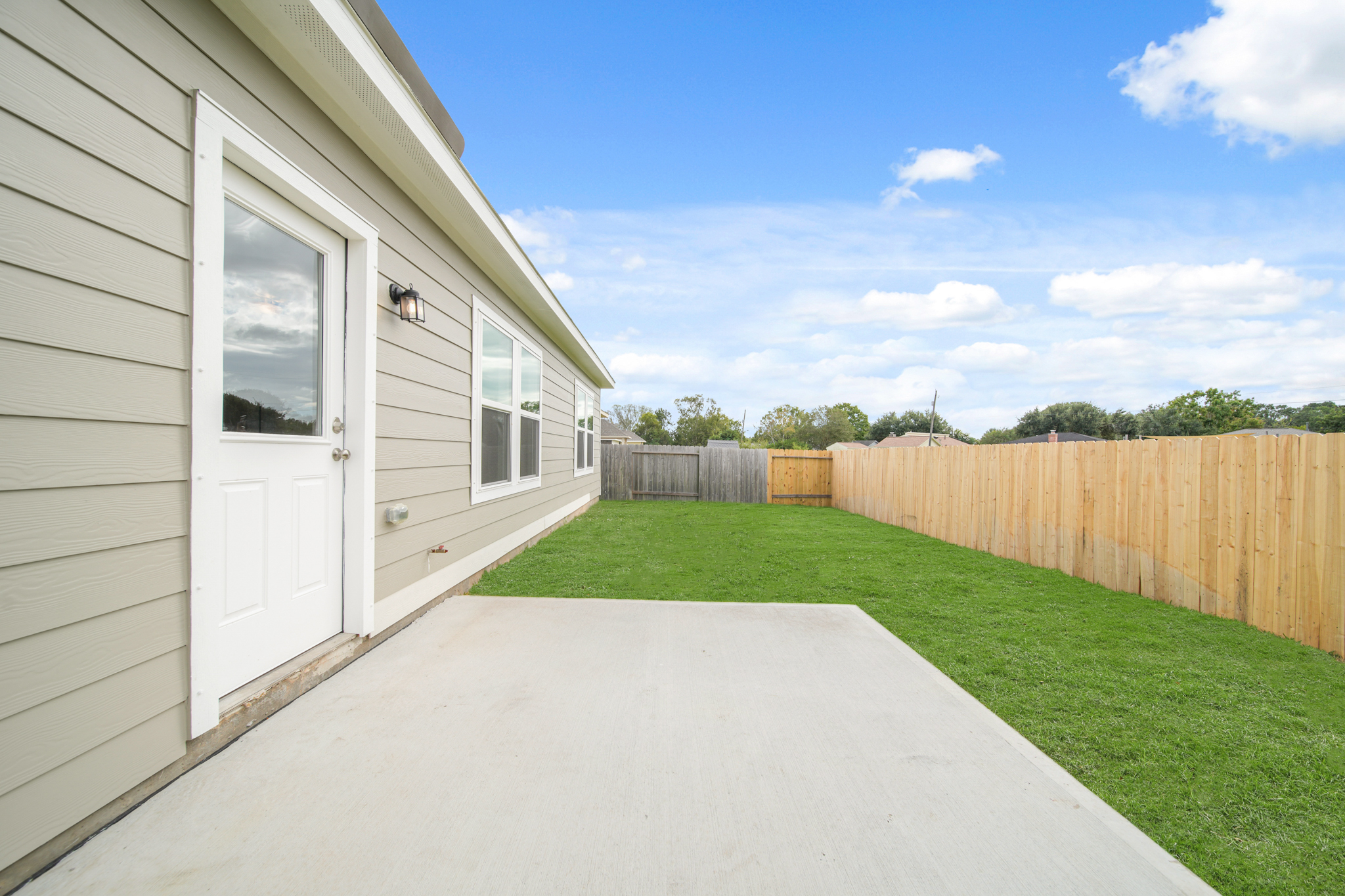 A house with a fence and grass.