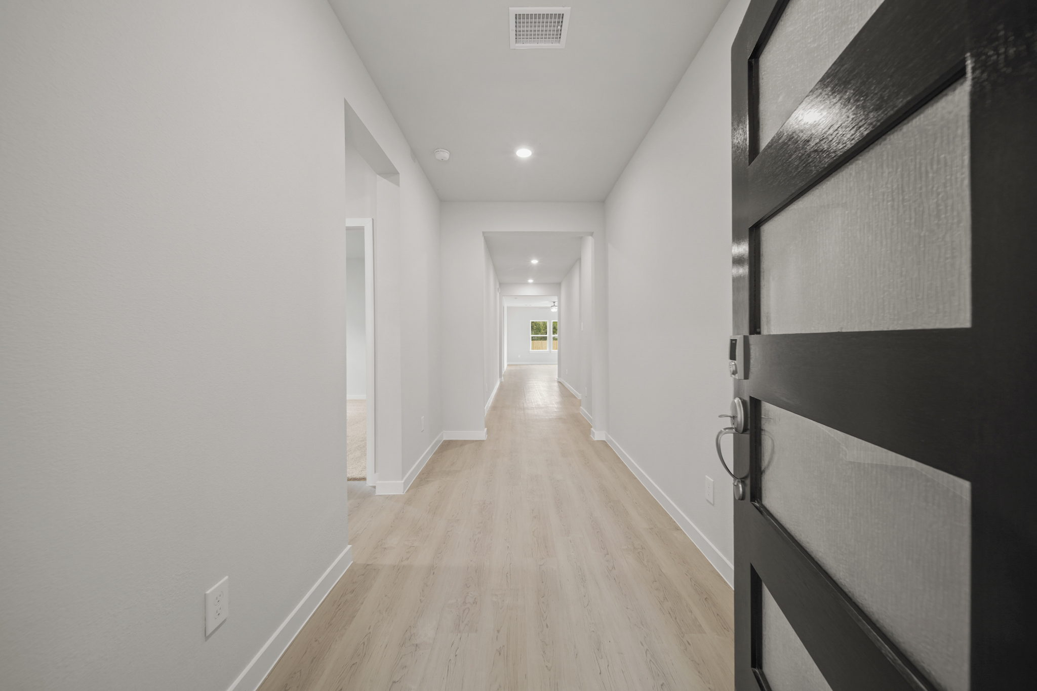 A long hallway with white walls.