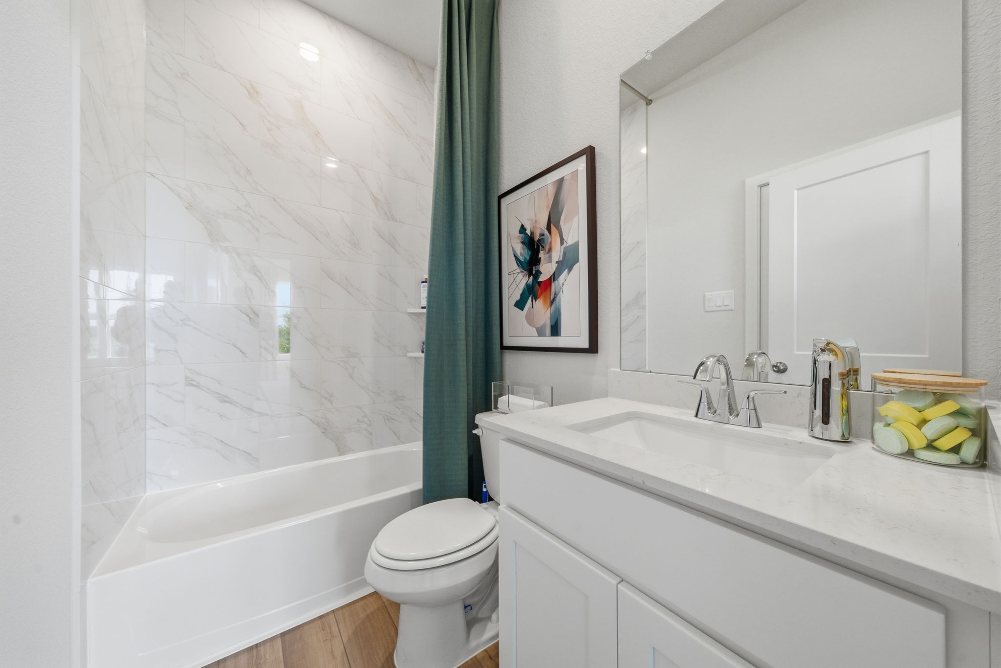 A bathroom with a tub toilet and sink.