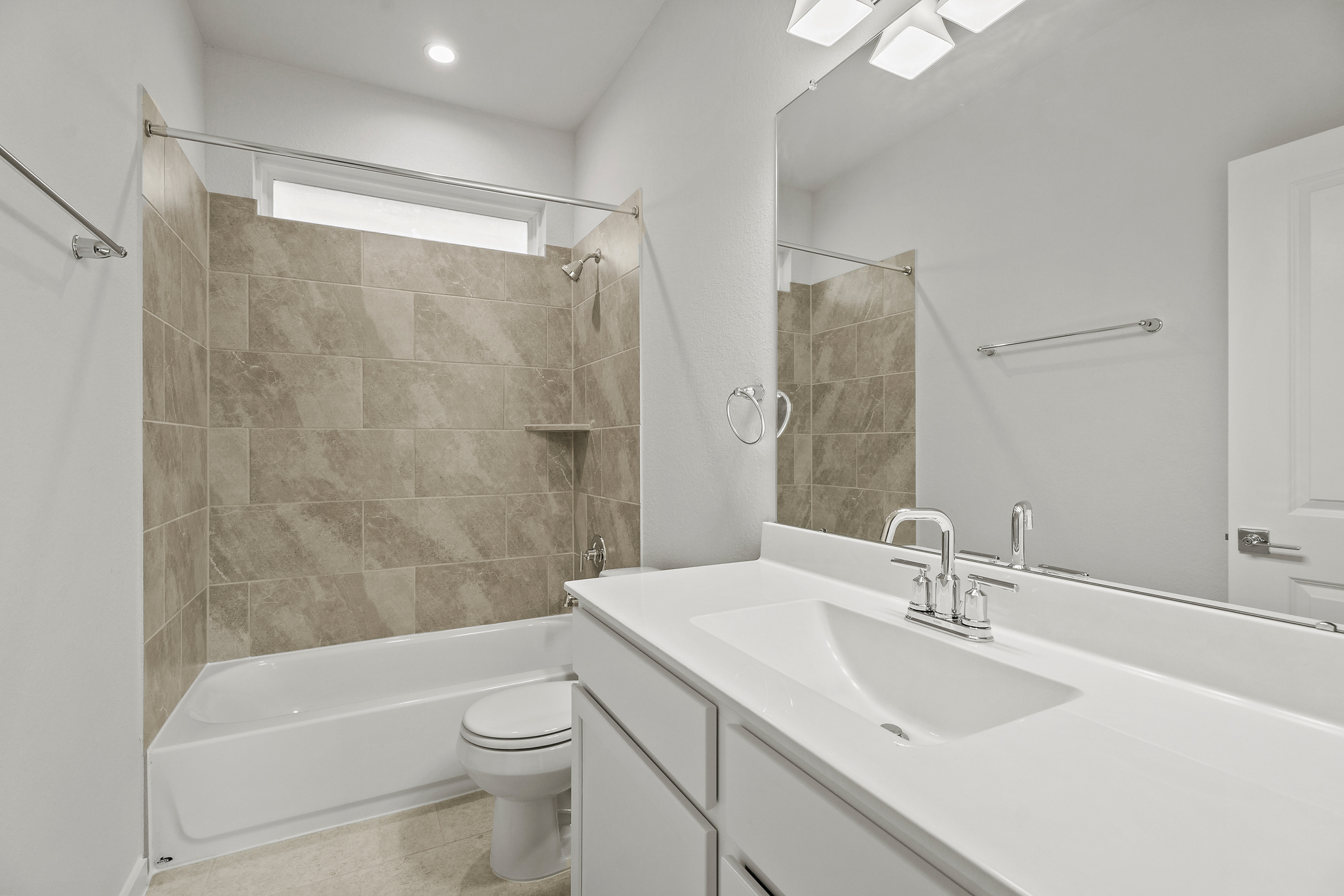 A bathroom with a tub sink and toilet.