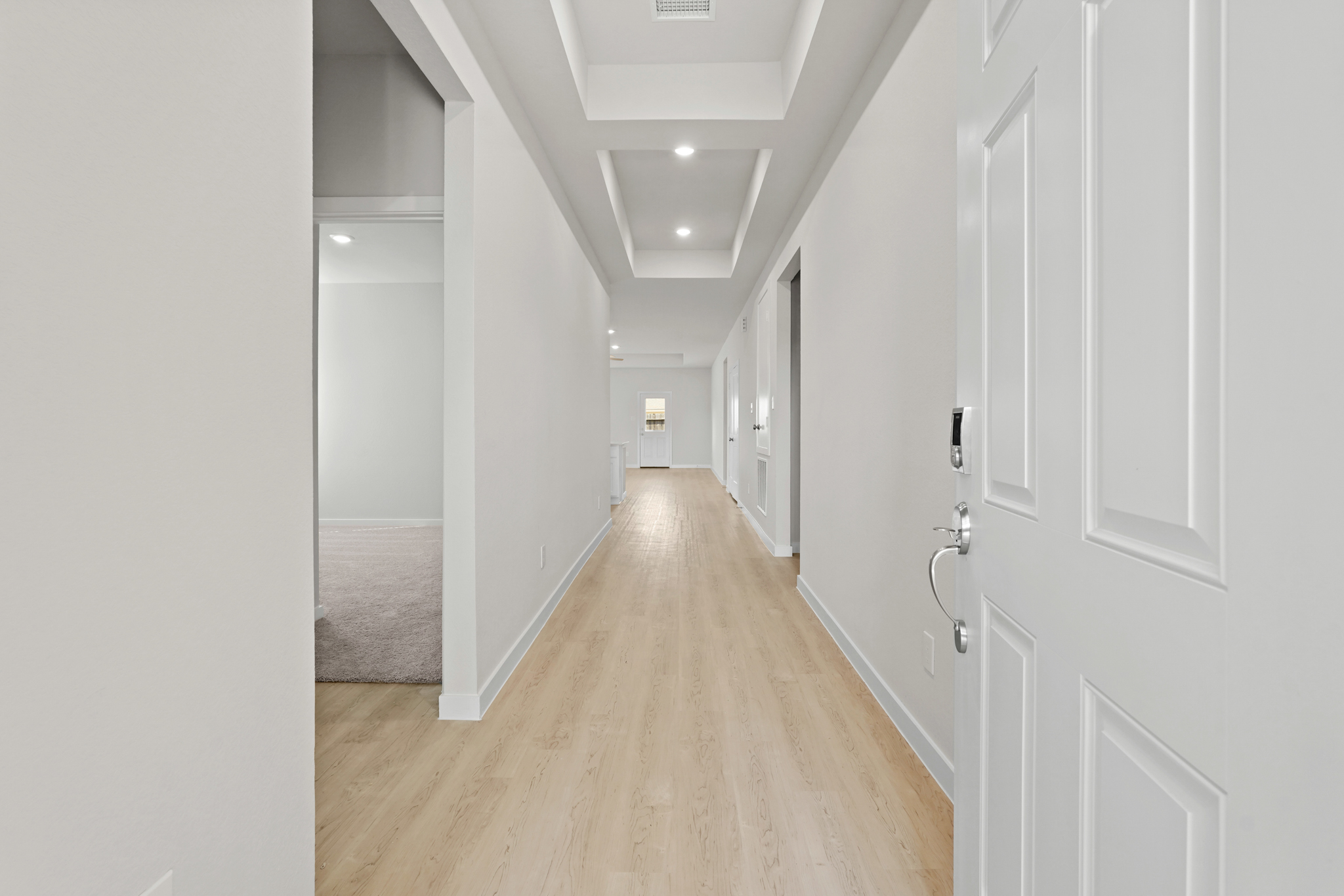 A hallway with white doors.
