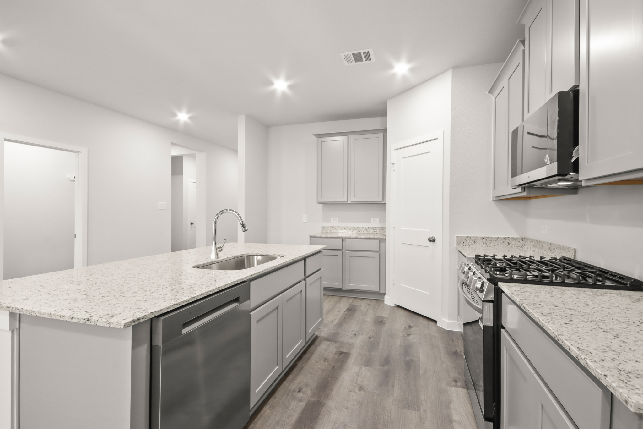A kitchen with white cabinets.