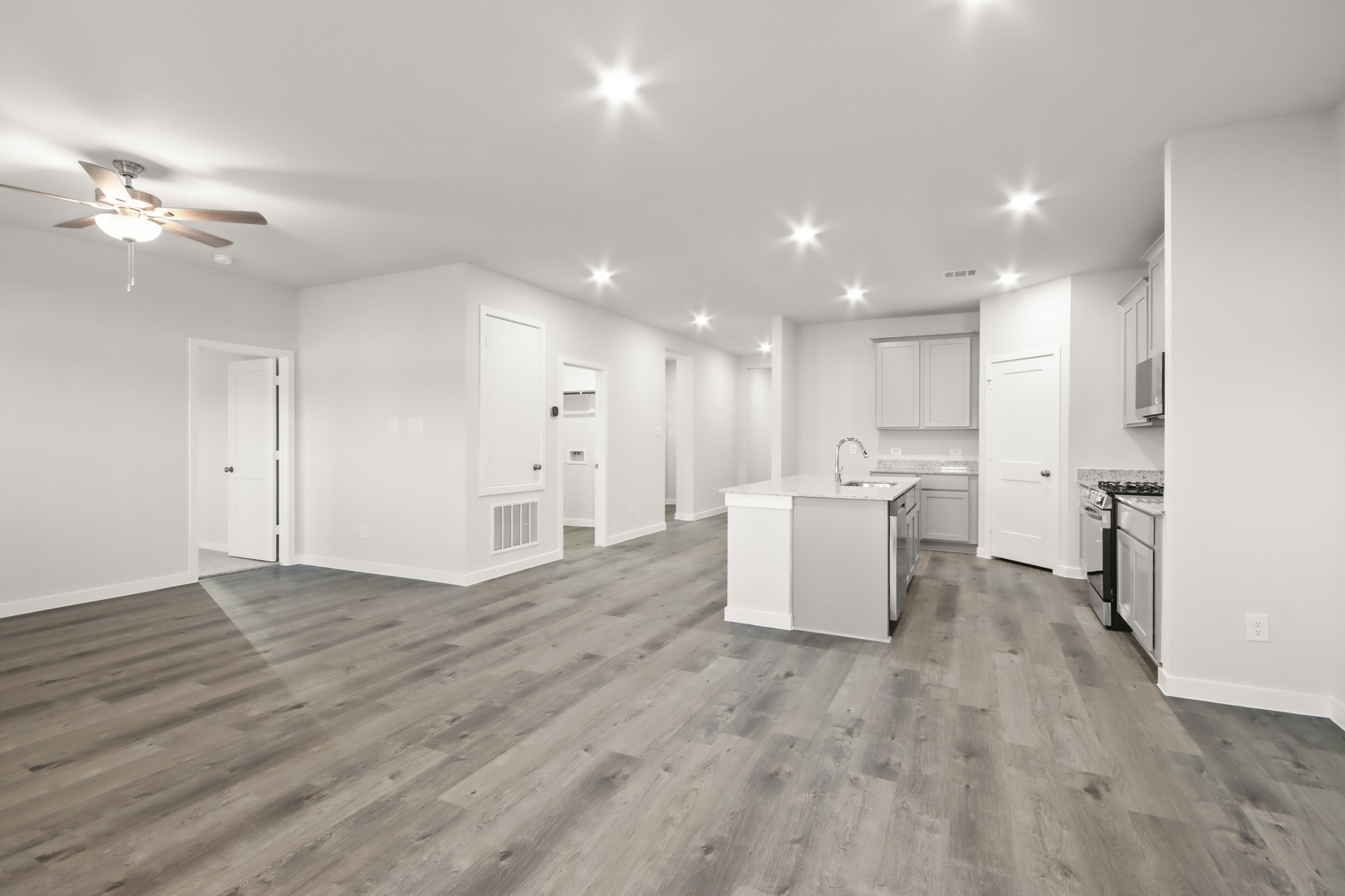 A kitchen with white cabinets.