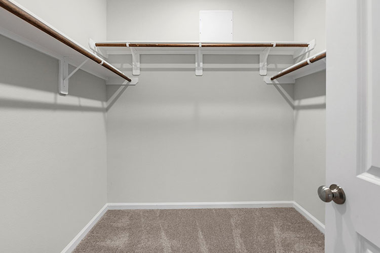 A white staircase with a rug.