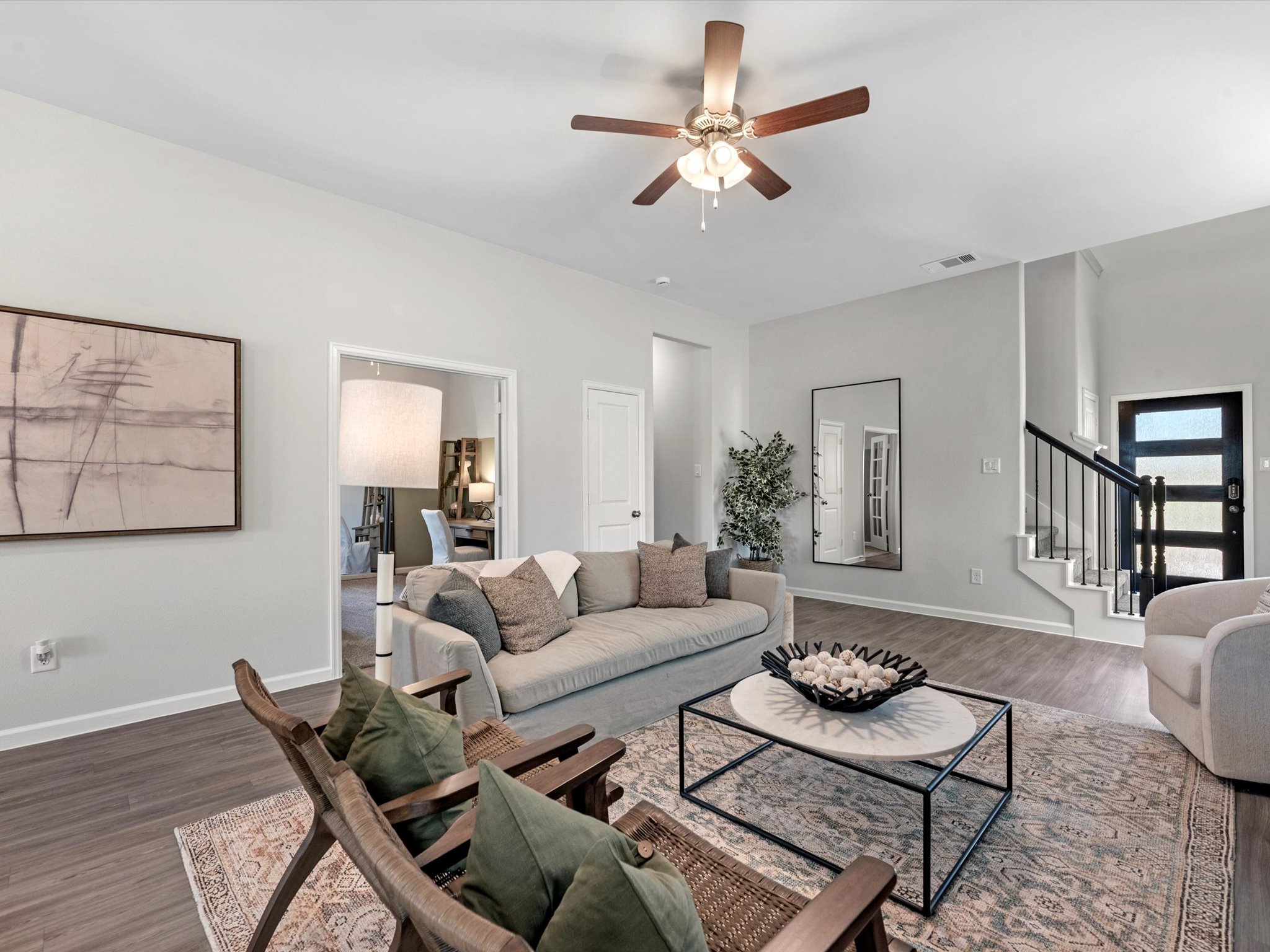 A living room with a ceiling fan.