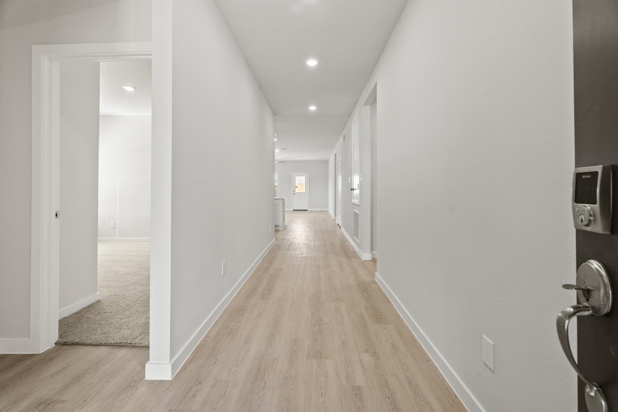A hallway with white walls.