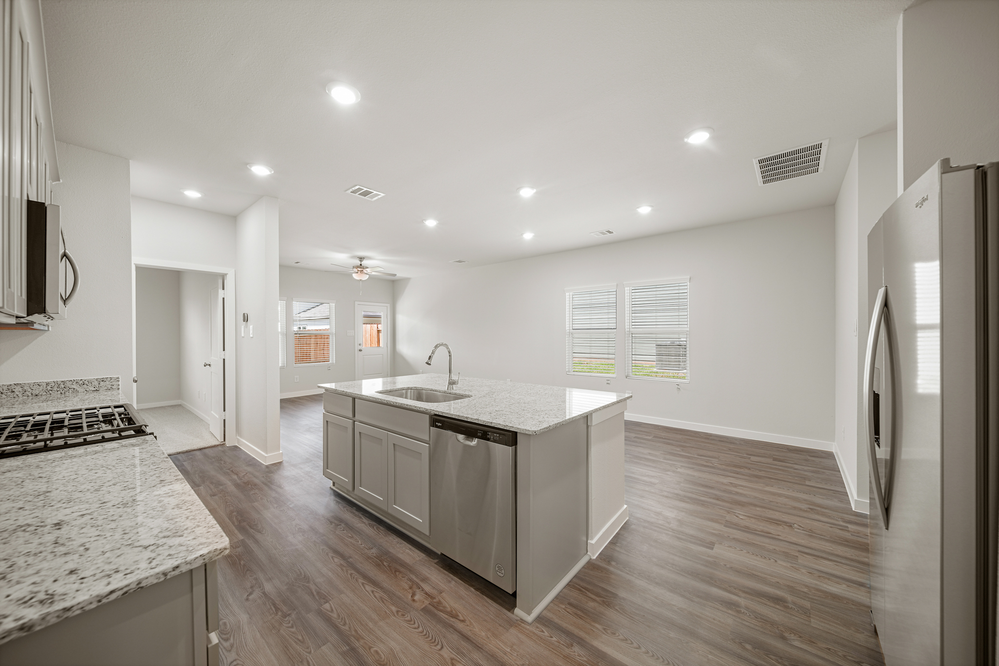 A kitchen with a marble island.