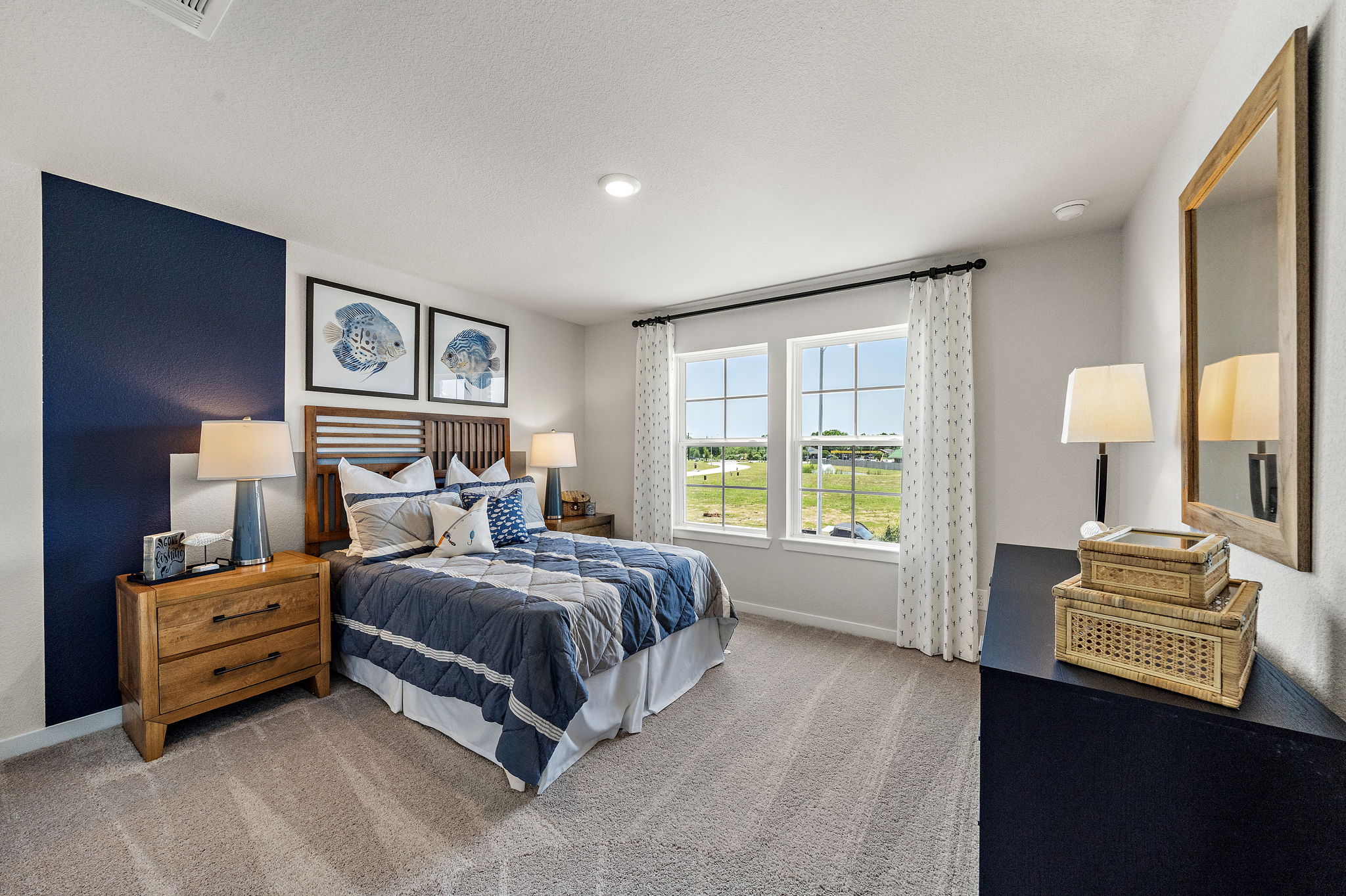 A bedroom with a bed and a mirror.