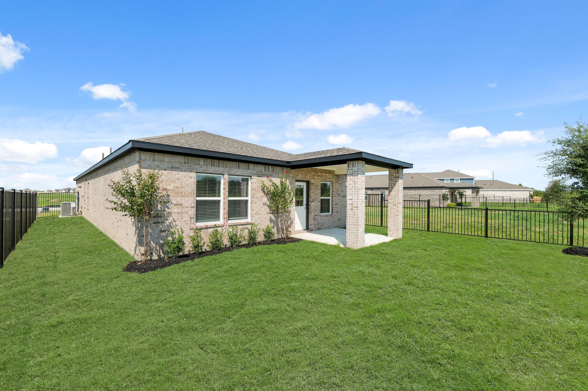 A house with a fence and trees.