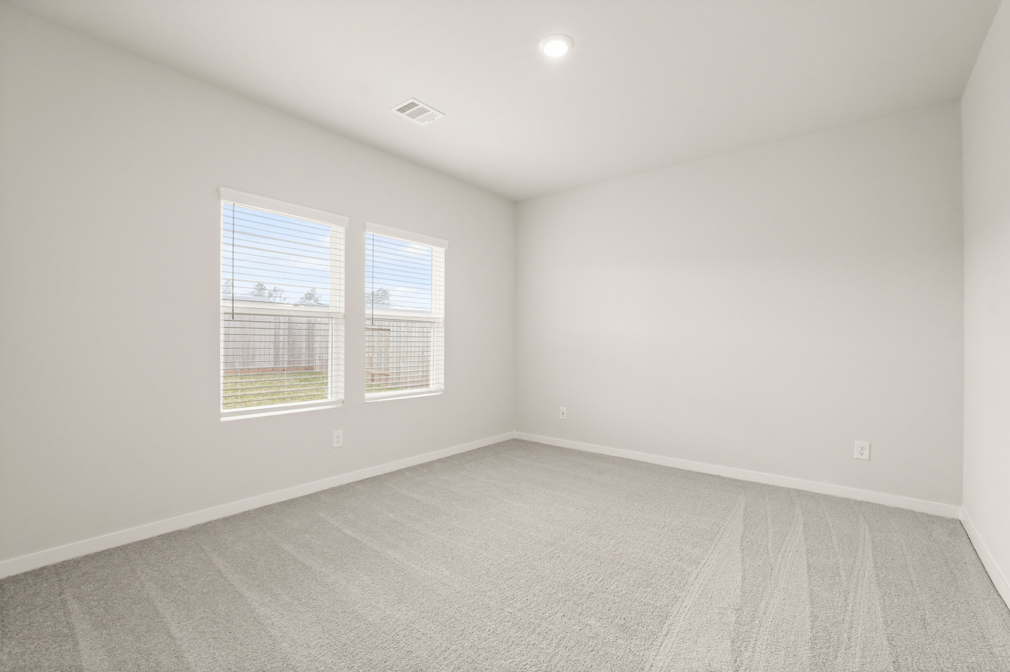 A room with a window and a carpet.