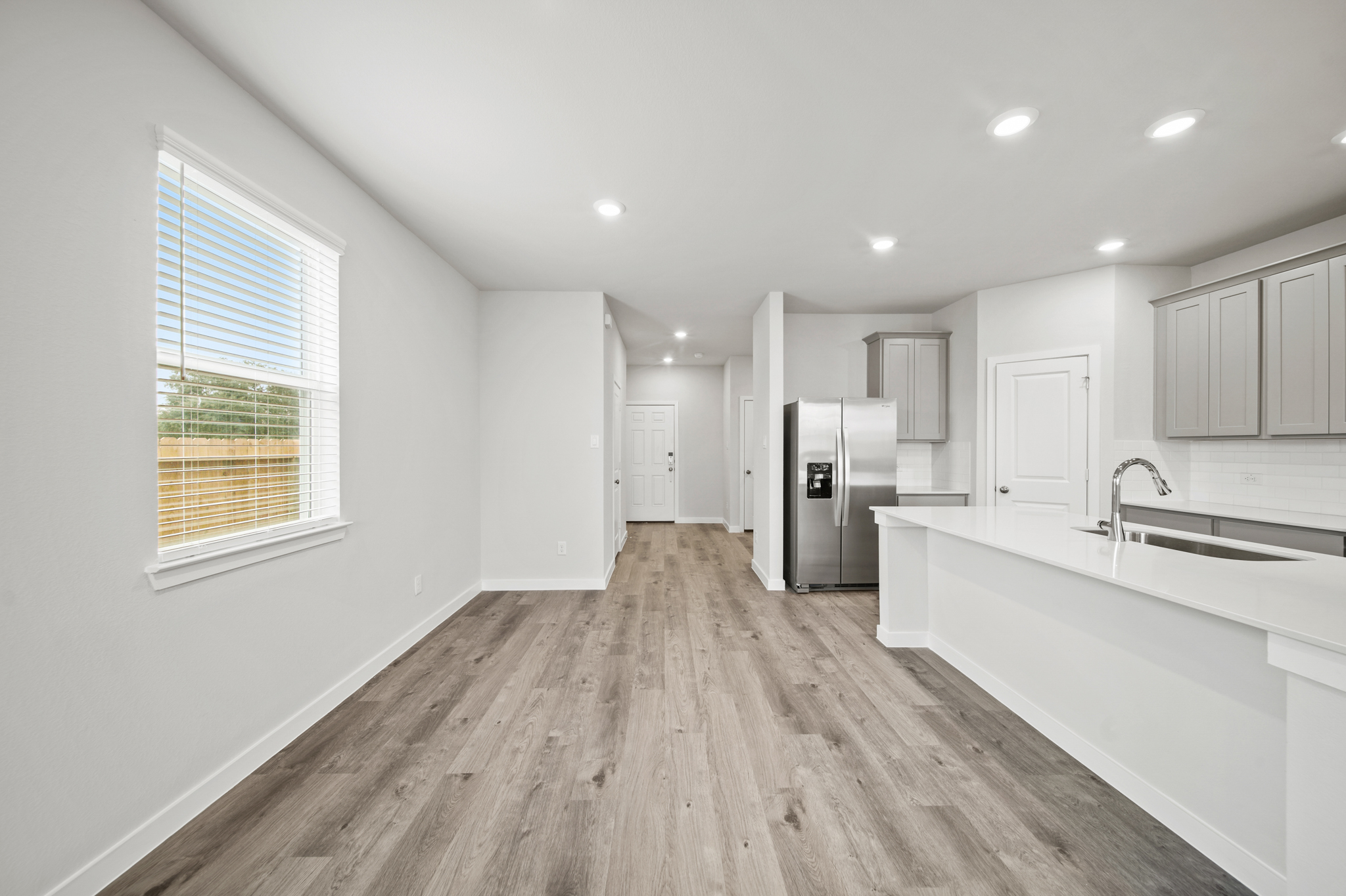 A kitchen with white cabinets.