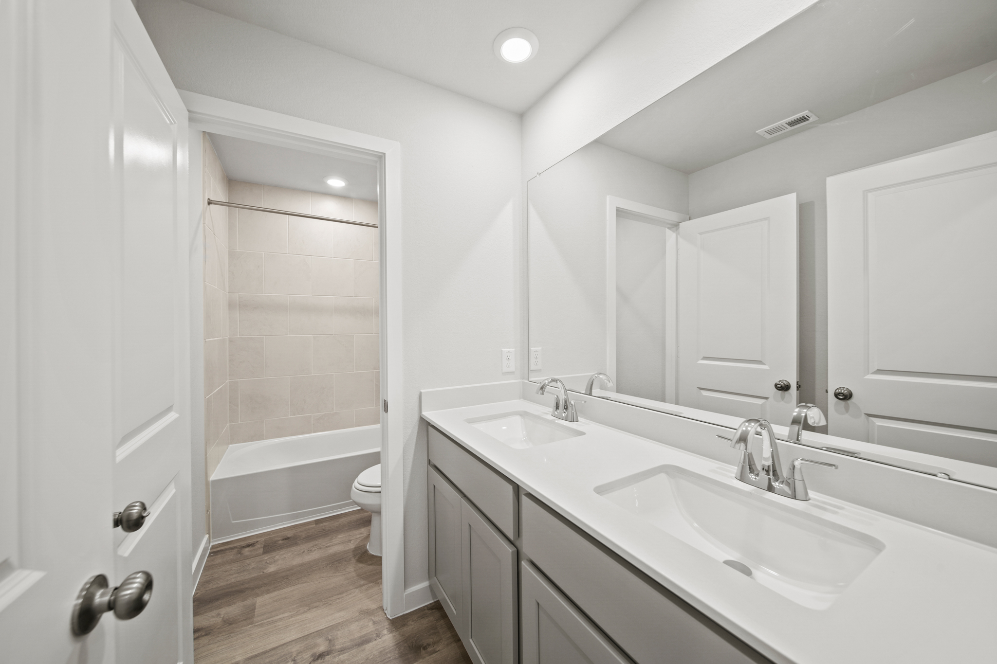 A bathroom with a tub sink and toilet.