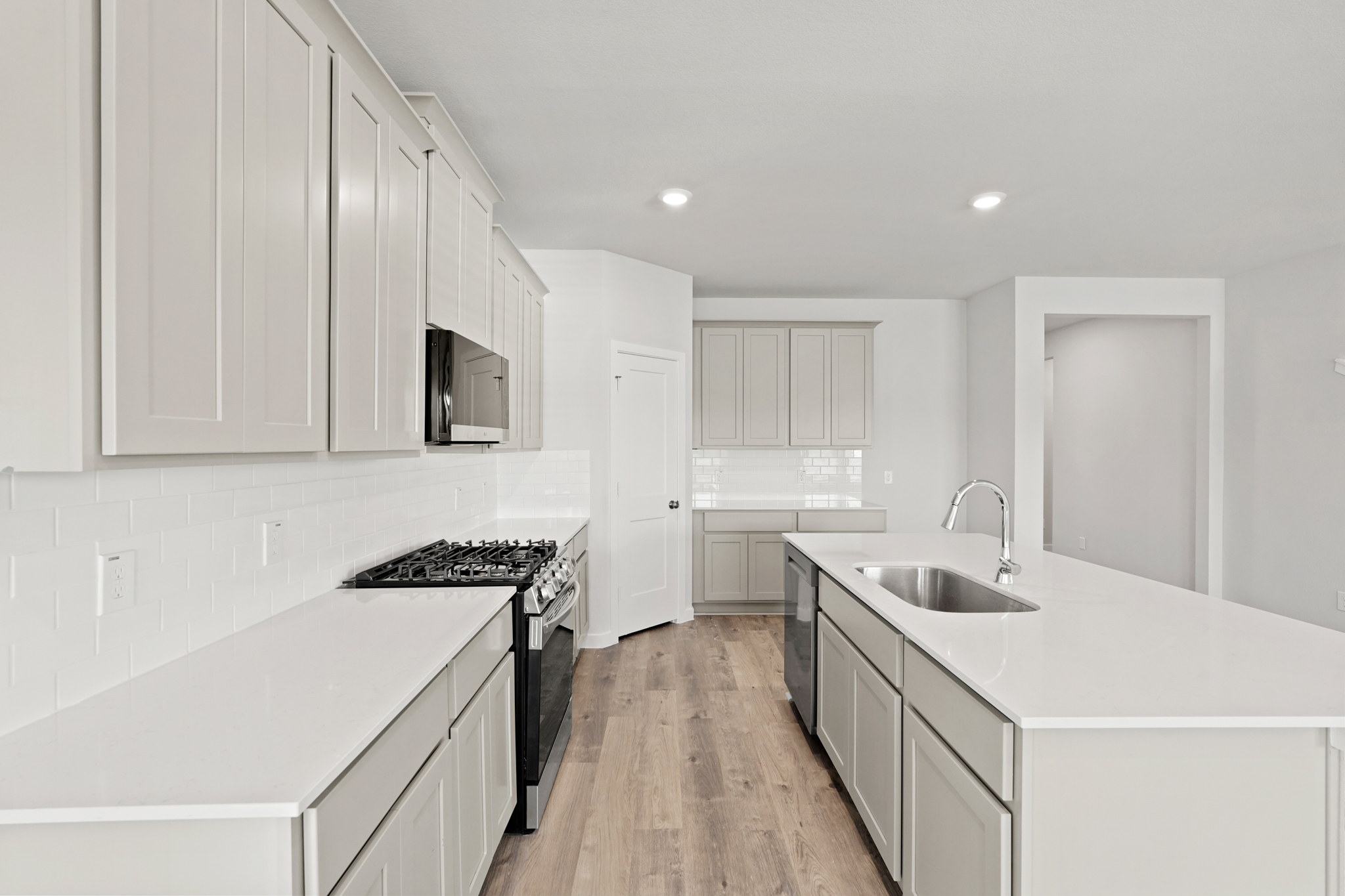 A kitchen with white cabinets.