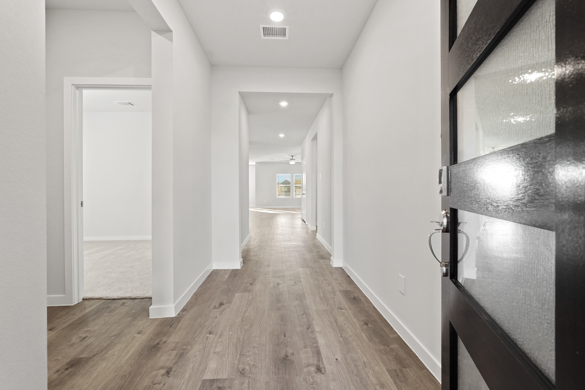 A hallway with white walls.