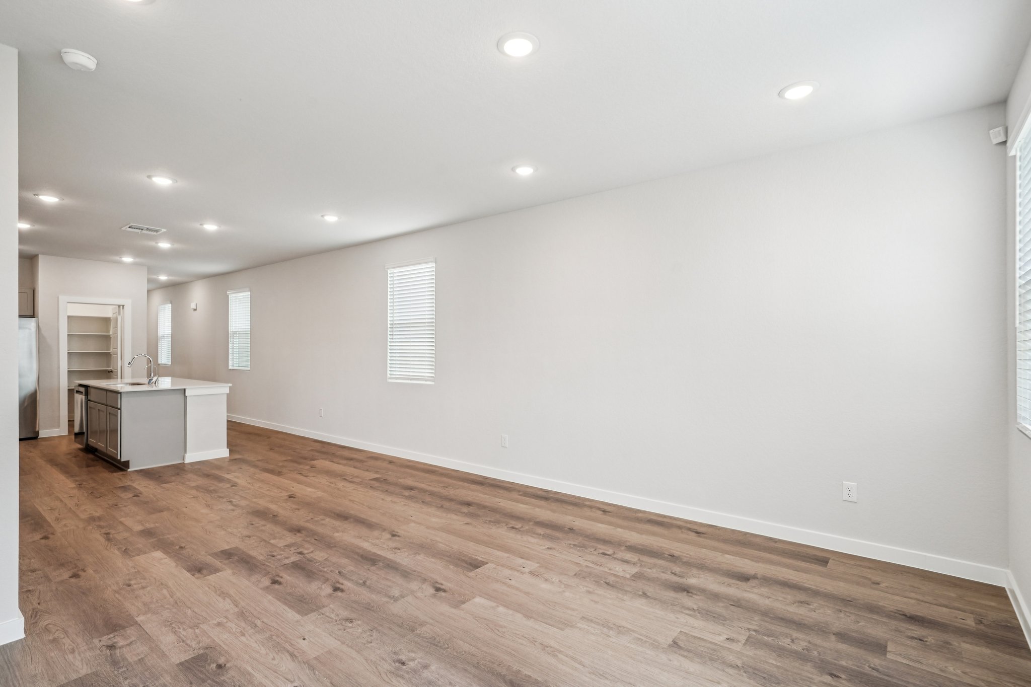 A room with a wood floor and white walls.