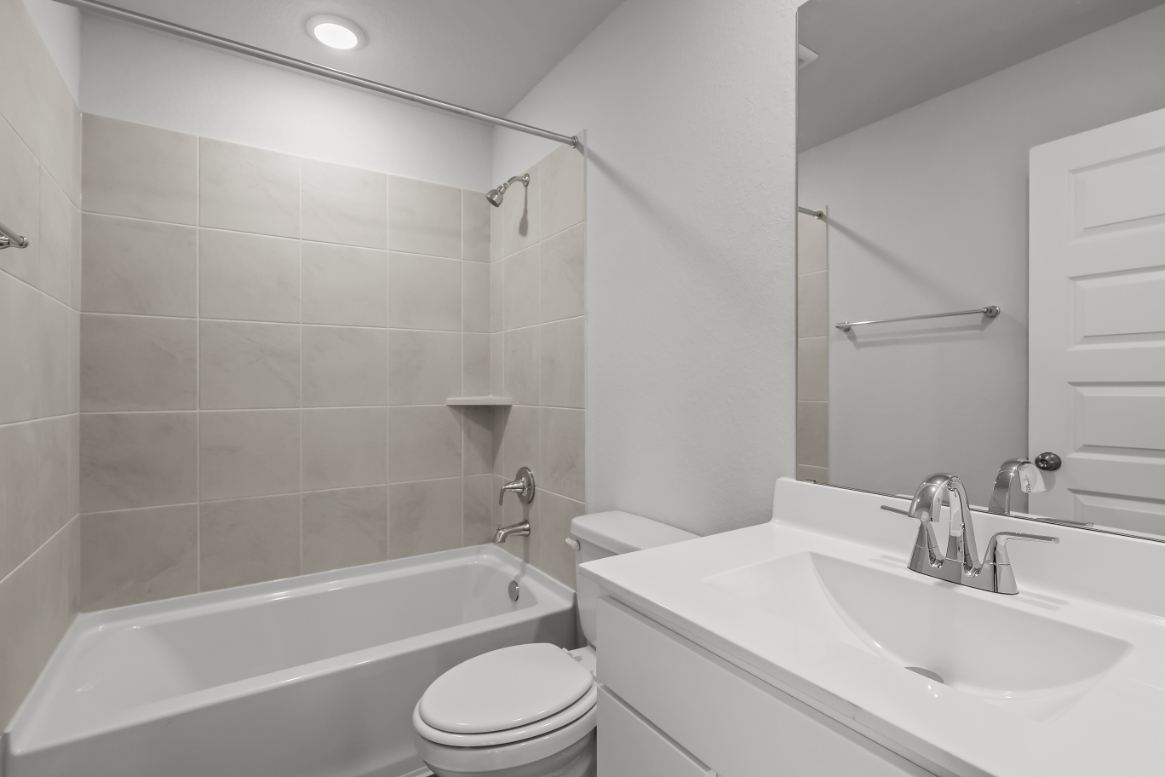 A bathroom with a sink toilet and bathtub.