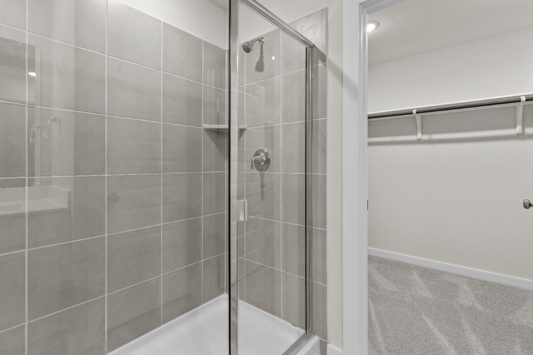 A shower with a glass door.