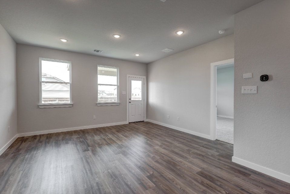 A room with a wood floor and white walls.