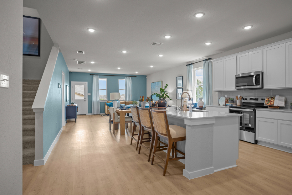 A kitchen with a wood floor.