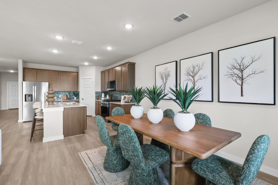 A kitchen with a dining table and chairs.