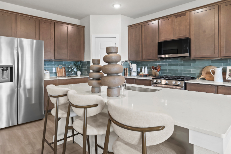 A kitchen with a table and chairs.
