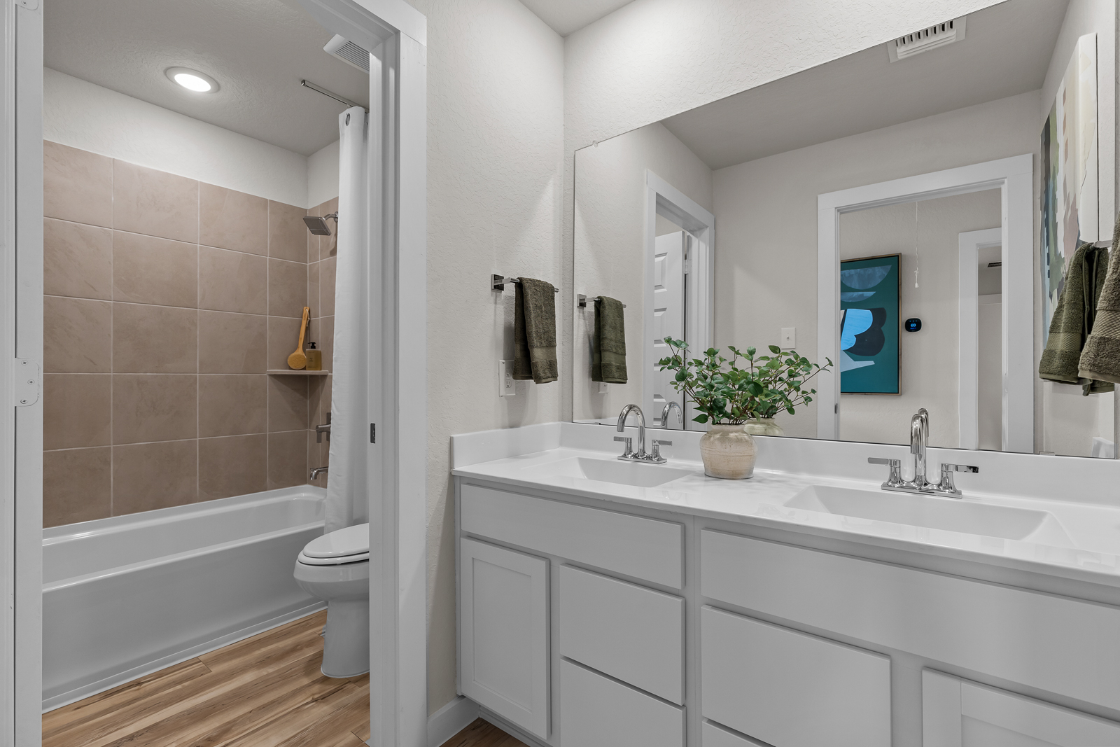 A bathroom with a tub sink and toilet.