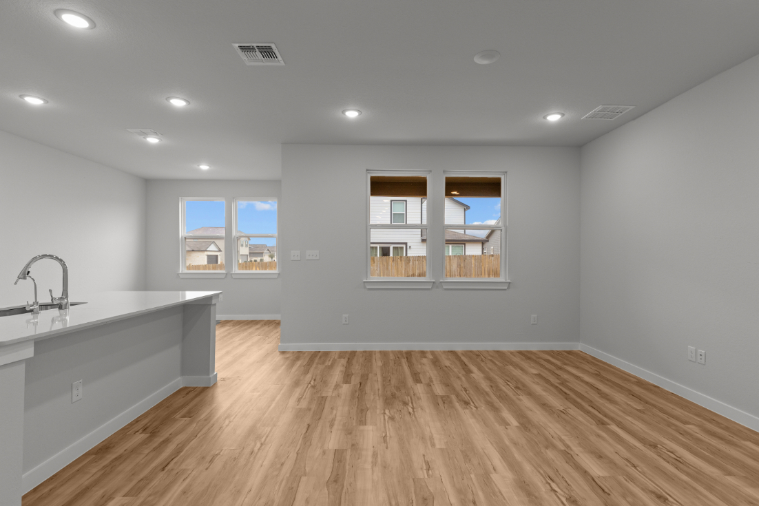 A kitchen with a wood floor.