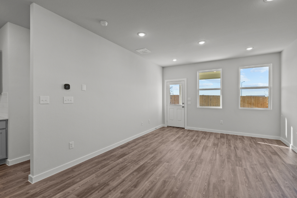 A room with white walls and a wood floor.