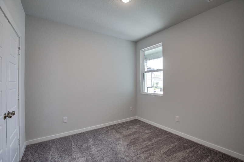 A room with a door and a window.