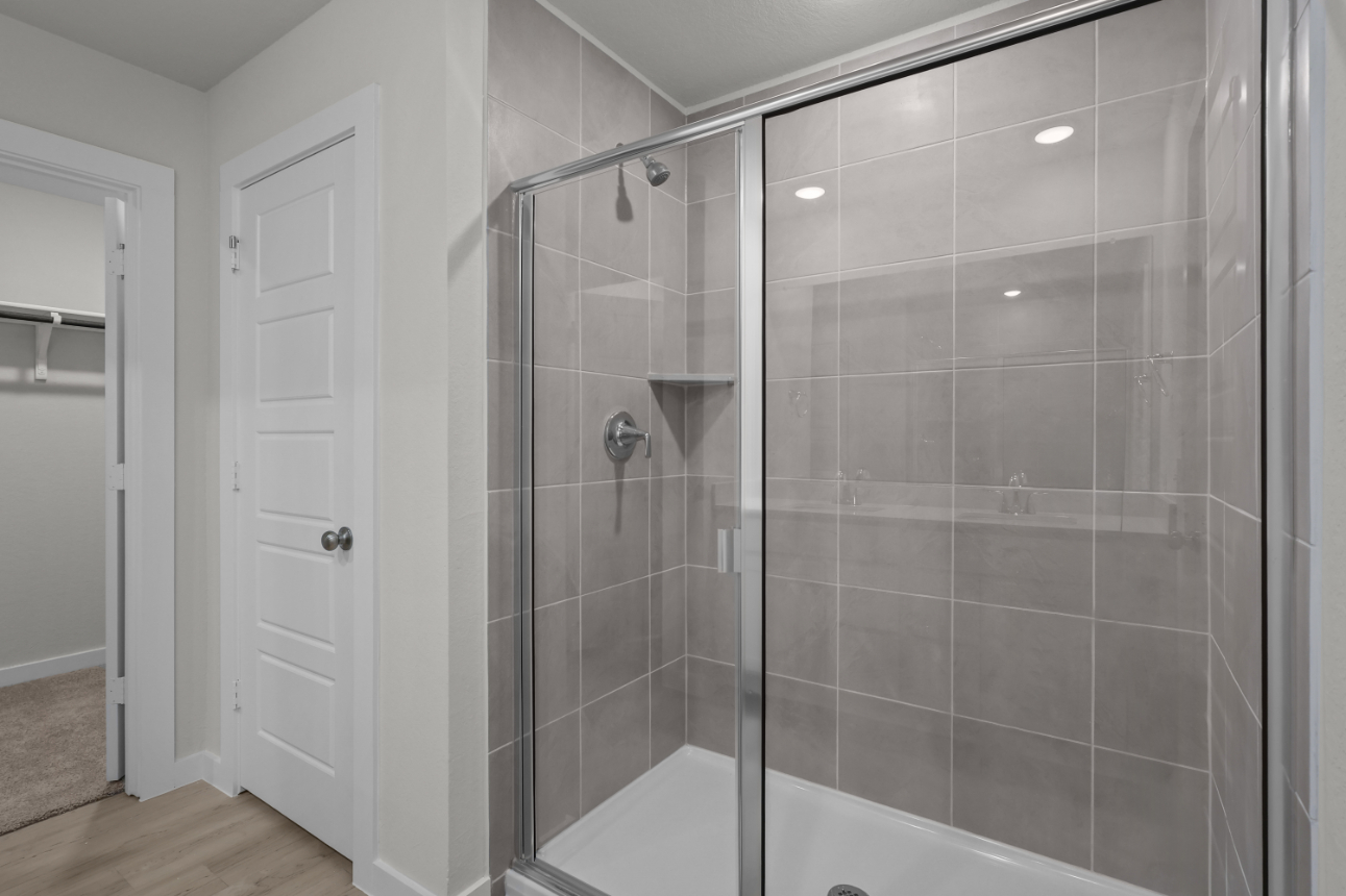 A shower with a glass door.