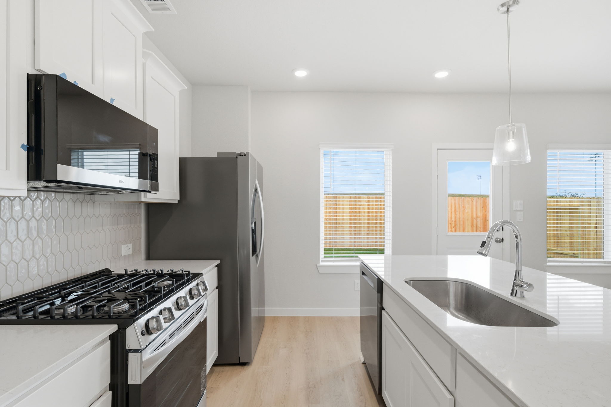 A kitchen with white cabinets.