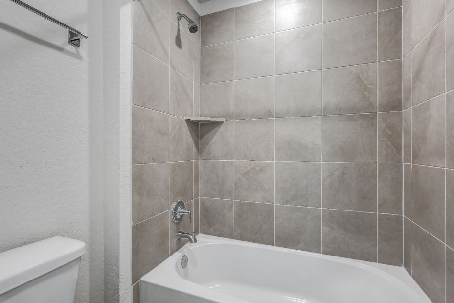 A bathroom with a bathtub and toilet.
