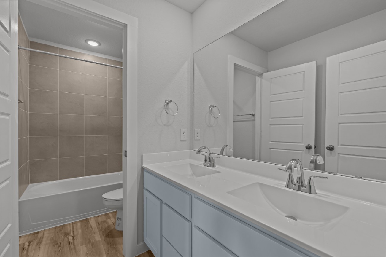 A bathroom with a tub sink and toilet.