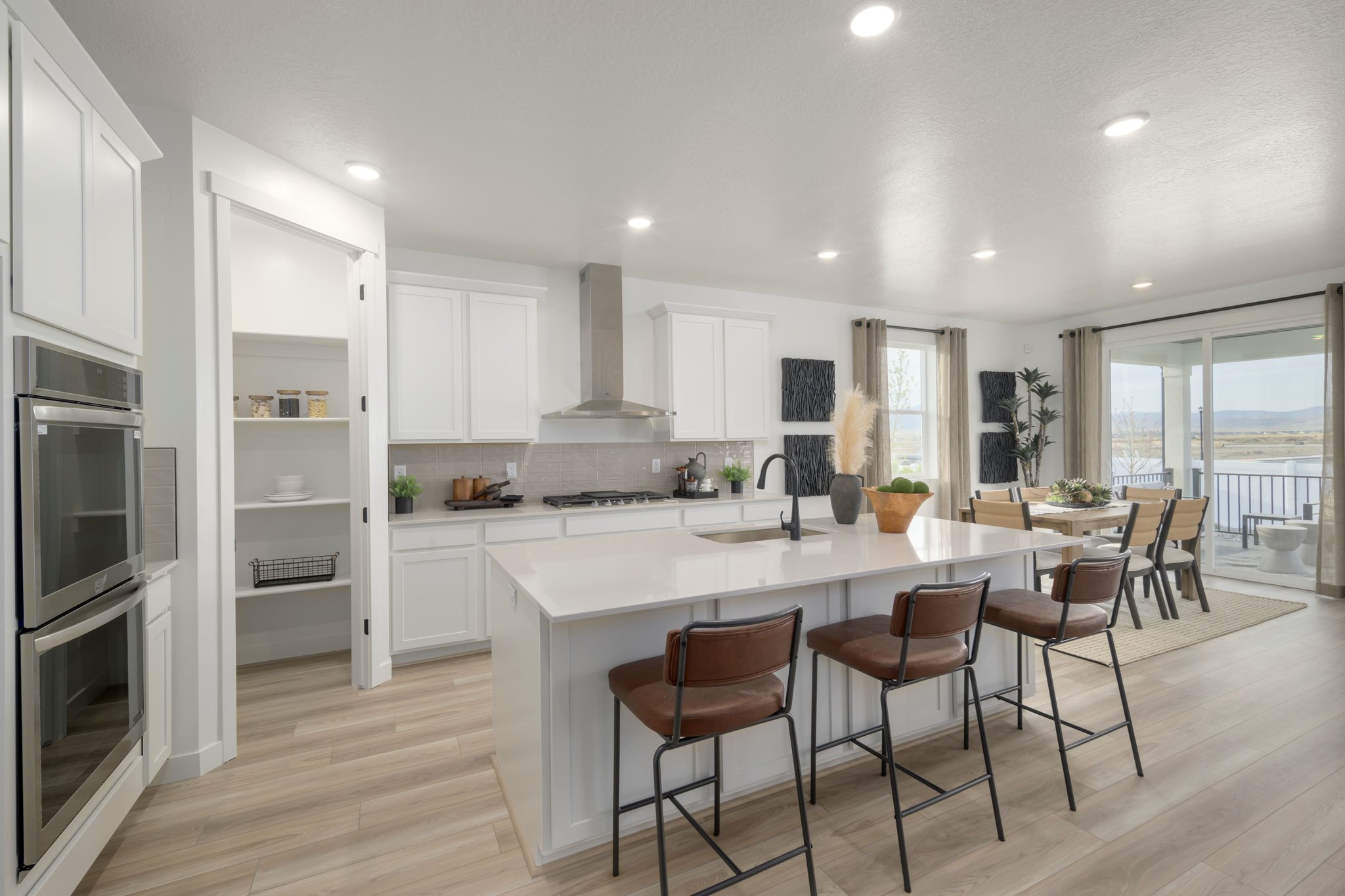 A kitchen with white cabinets.