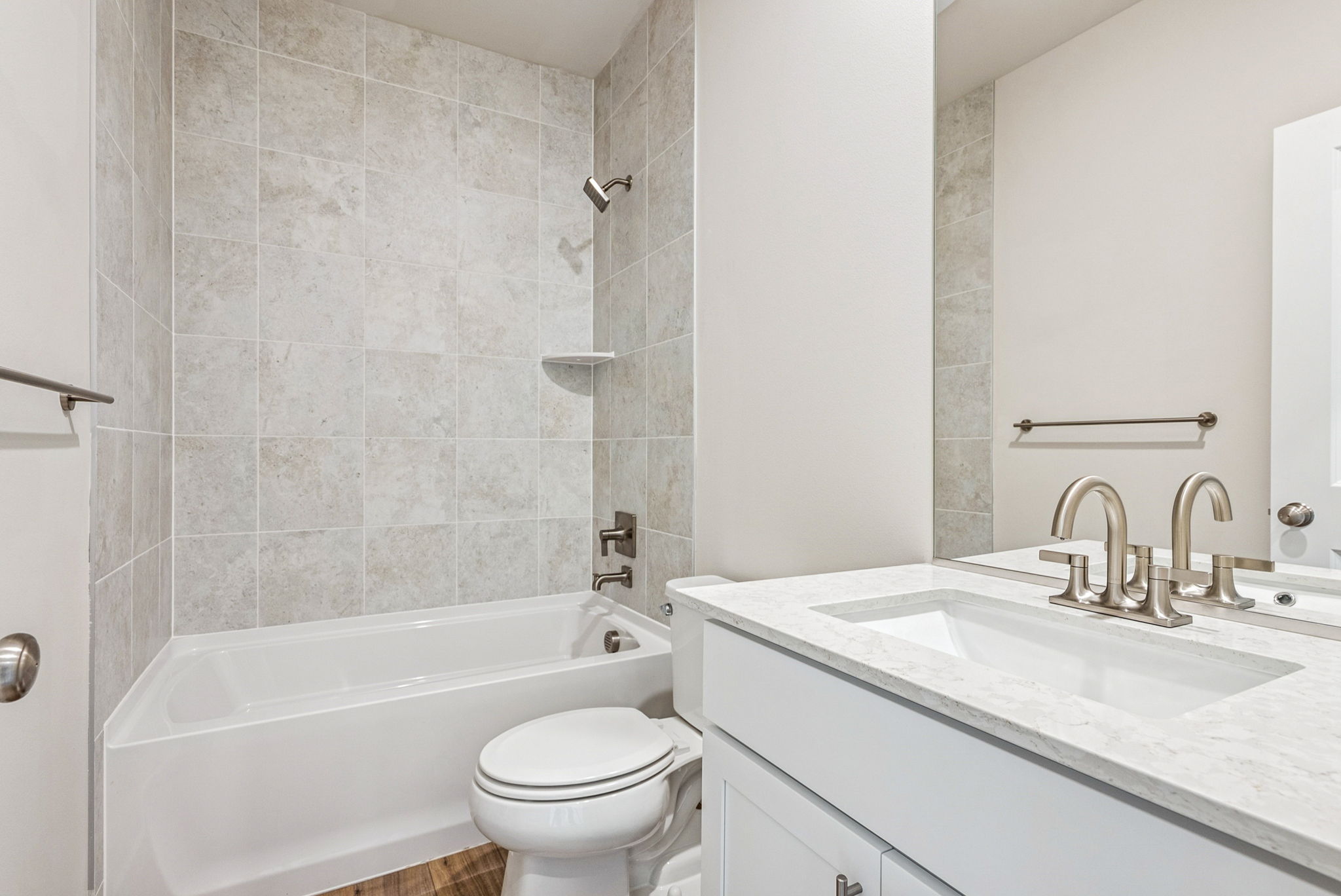 A bathroom with a tub sink and toilet.
