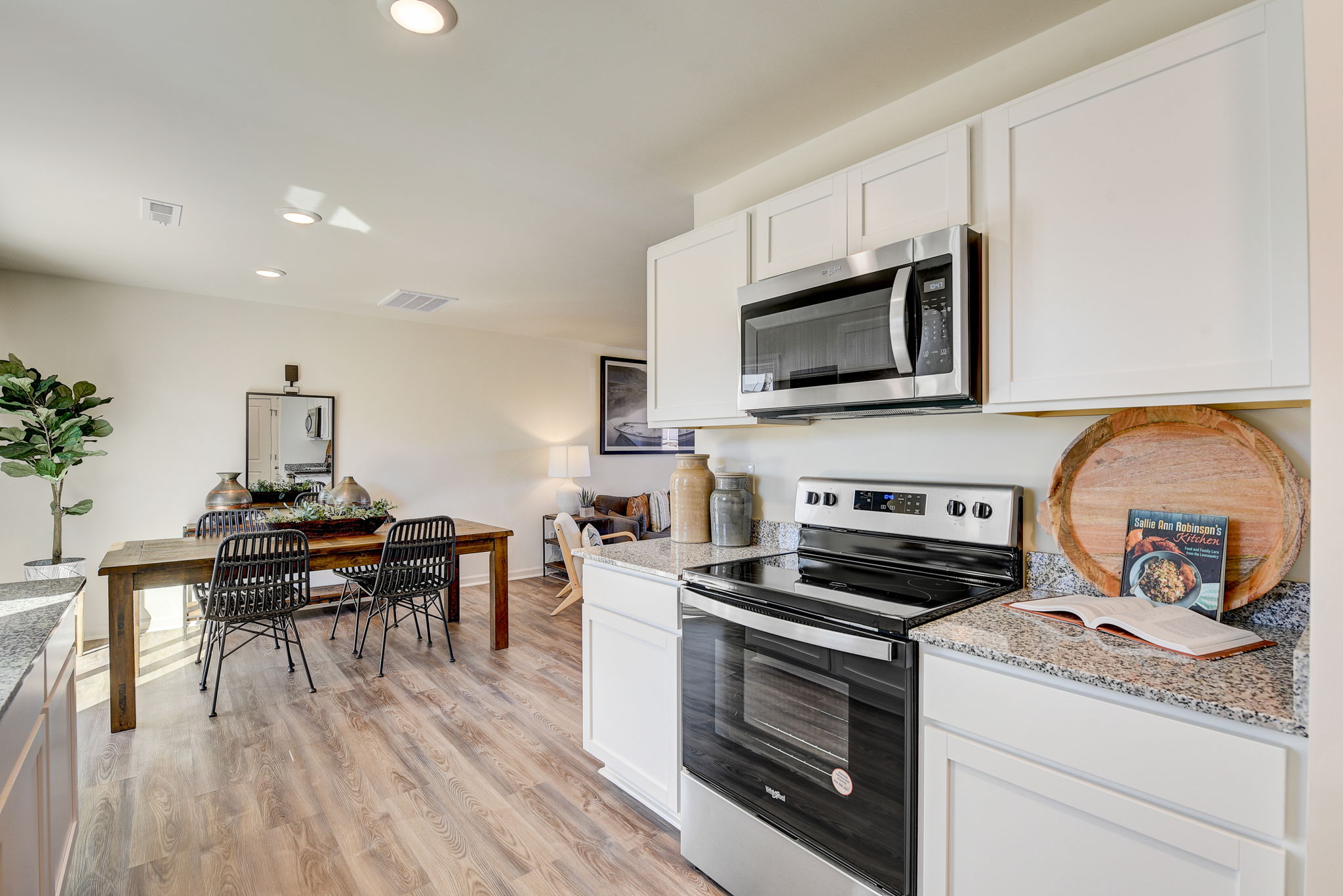 A kitchen with white cabinets.