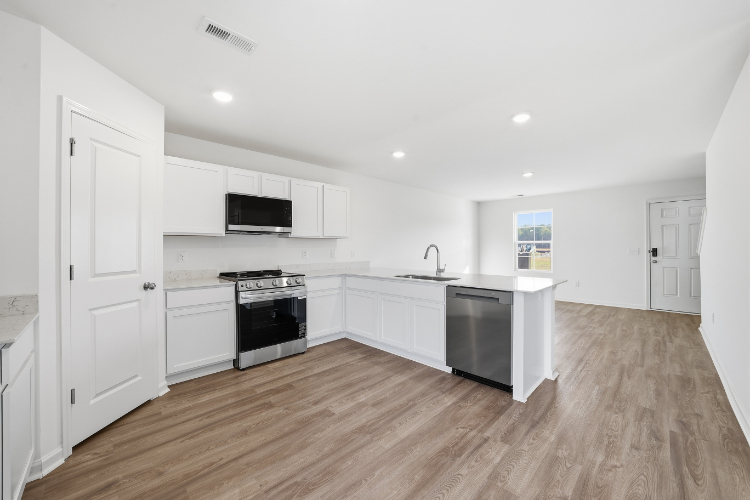 A kitchen with white cabinets.