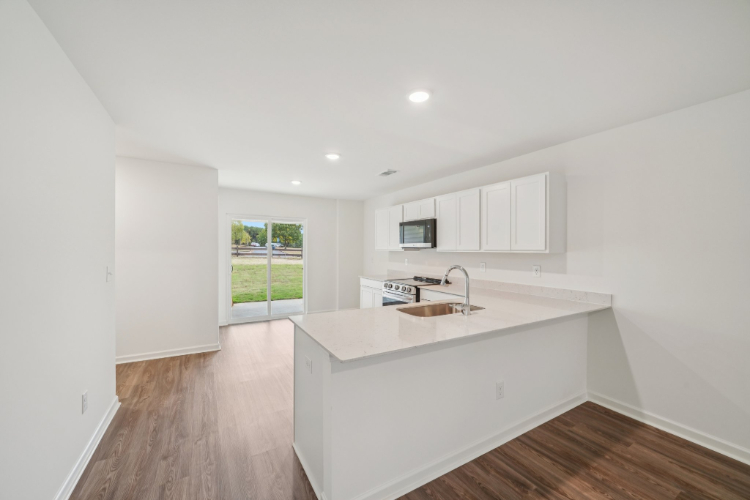 A kitchen with white cabinets.