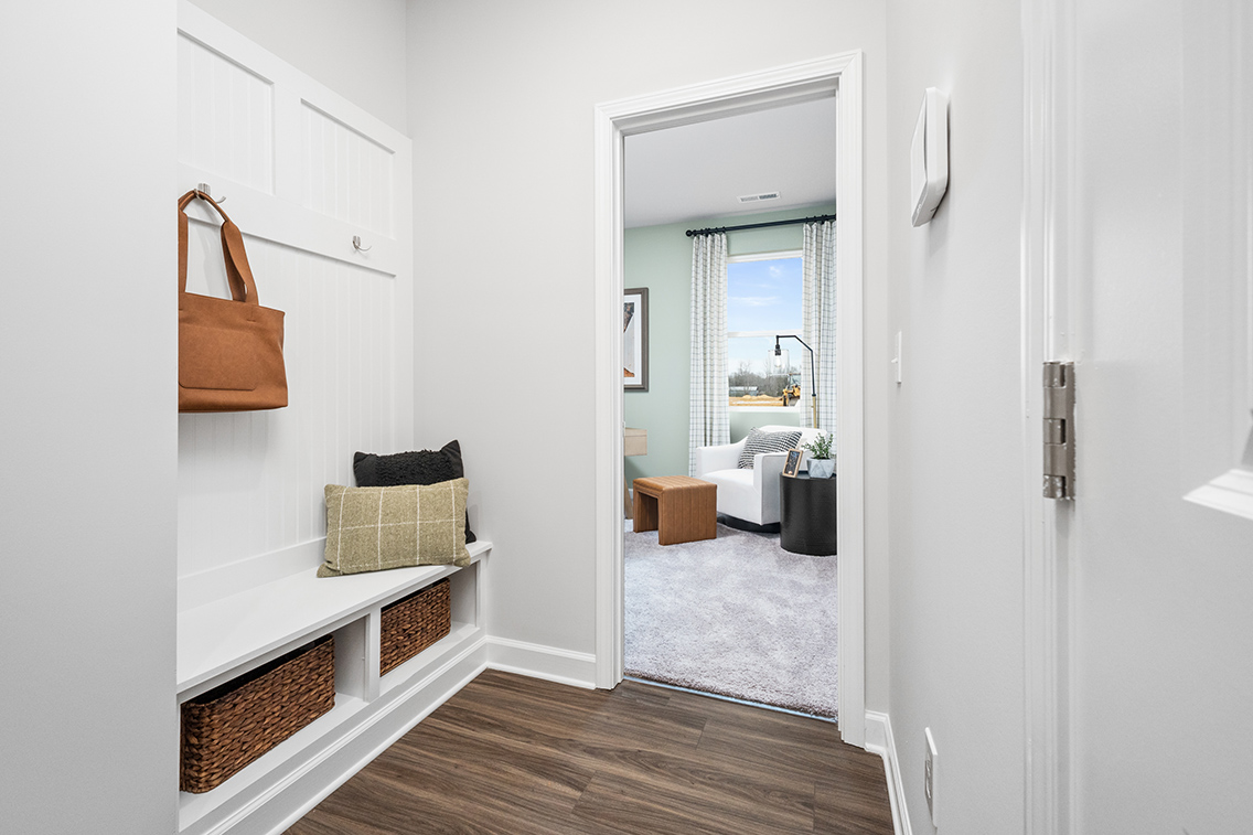 A room with a bed and a mirror.