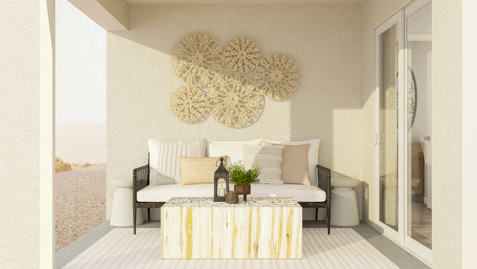 A room with a couch and a table with a bottle of wine.