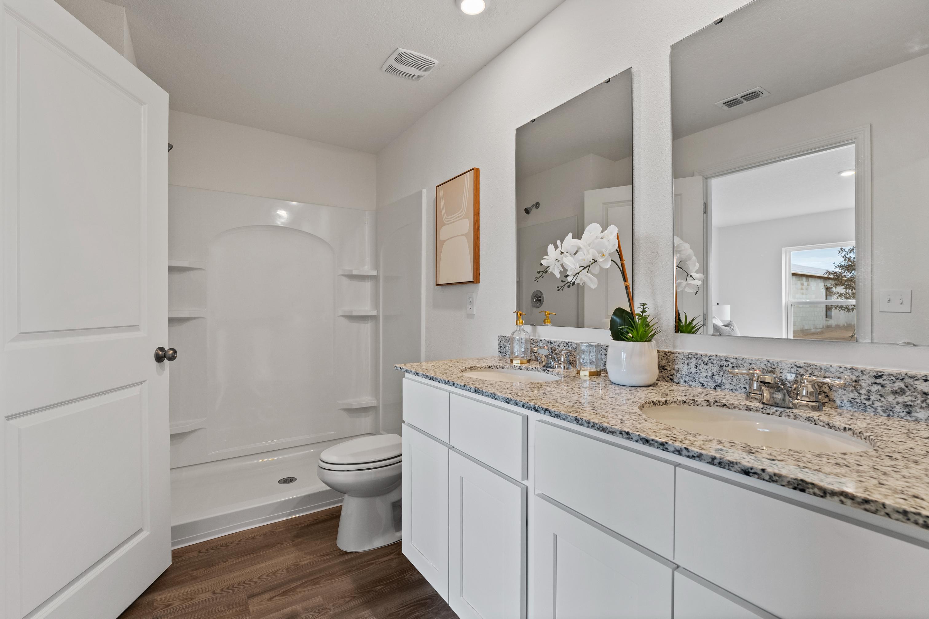A bathroom with a marble countertop.