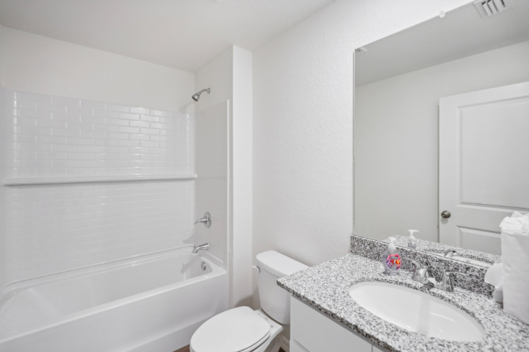 A bathroom with a sink and a toilet.