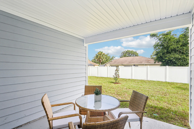 A table and chairs on a deck.