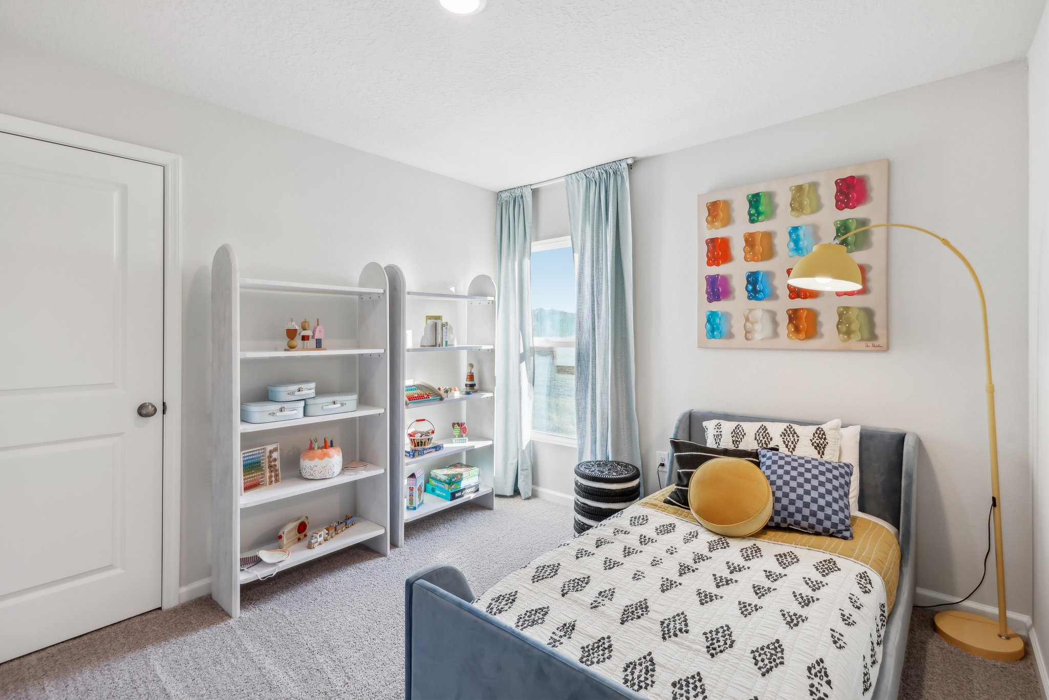 A bedroom with a bed and shelves.