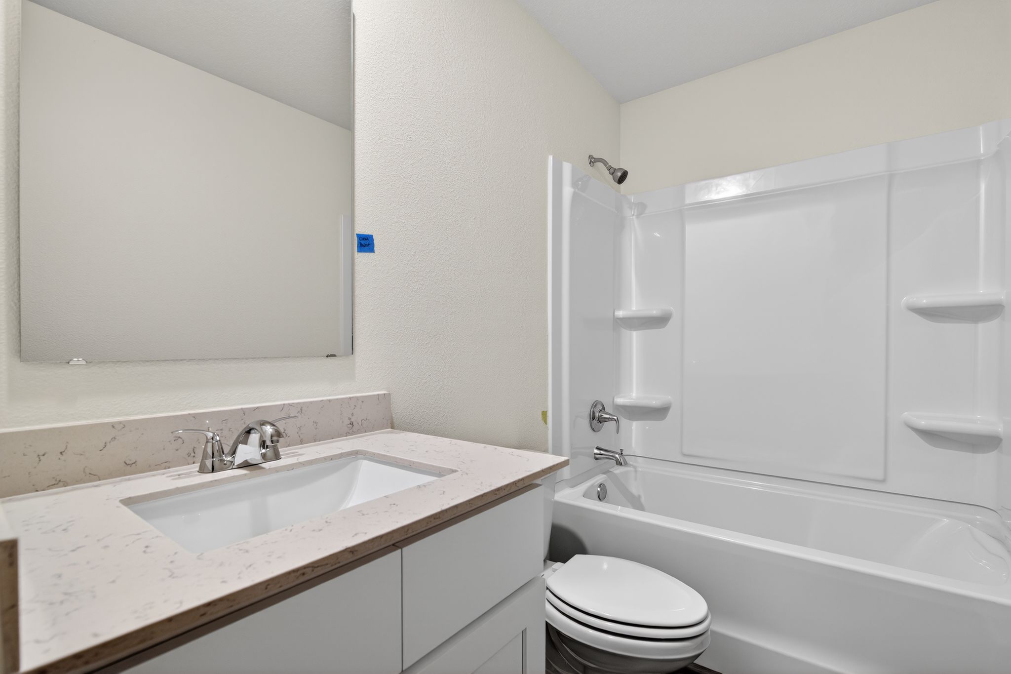 A bathroom with a sink toilet and bathtub.